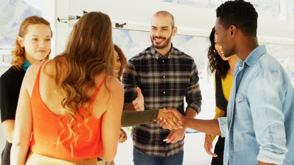 Business colleagues shaking hands in the office