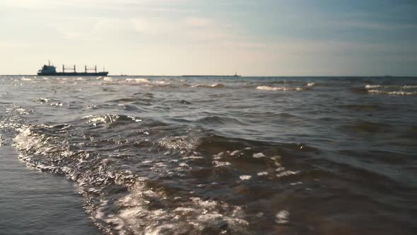 Boat sailing along the horizon at sunset