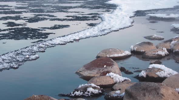 Snow Boulders in Frozen Winter River