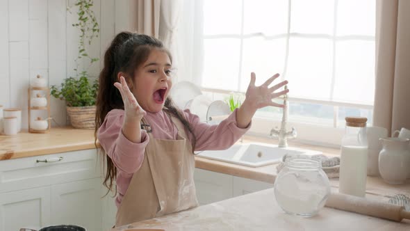 Cute Arabic Little Girl Having Fun With Flour In Kitchen