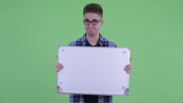 Stressed Young Hipster Man Holding White Board