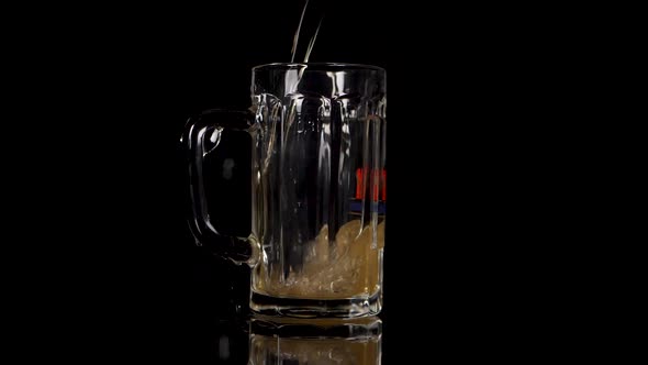 Slow motion pouring beer in a glas, some drops are going wrong.