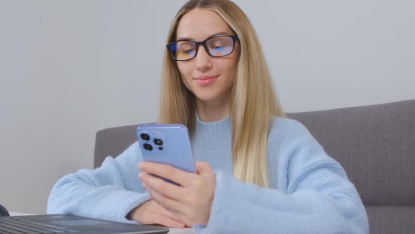 Happy white female using modern blue mobile phone for online communication in 4k video