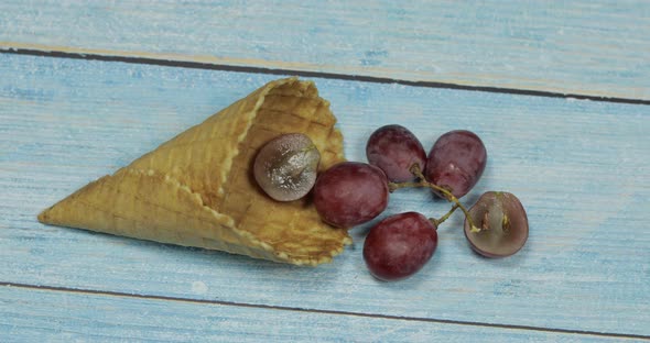 Berry Ice Cream. Berries of Grape in a Waffle on a Blue Wooden Background