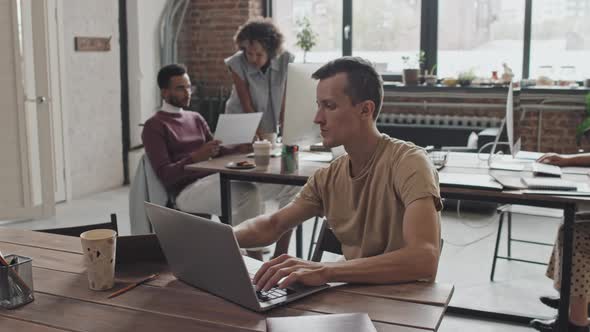 Male IT Specialist Working in Office