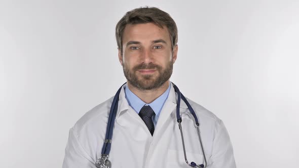 Tired Doctor Looking at Camera in Studio on White Background