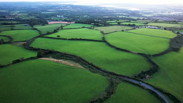 AERIAL: Fly across lush green farmer's fields, Gower, 4k Drone