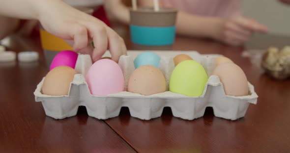 a Few Hands Take Eggs From a Casserole