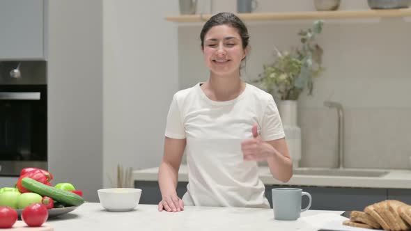 Indian Woman Showing Thumbs Up While Standing in Kitchen