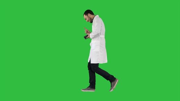 Walking attractive laughing doctor on a Green Screen, Chroma Key