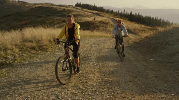 Couple Cycling on Sport Bikes in Mountains