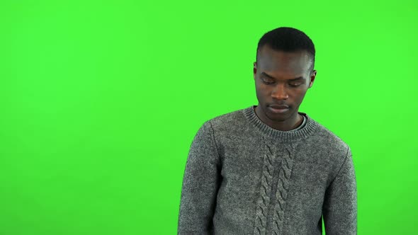 A Young Black Man Looks Around, Bored - Green Screen Studio