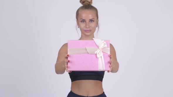 Happy Young Beautiful Blonde Woman Giving Gift Box