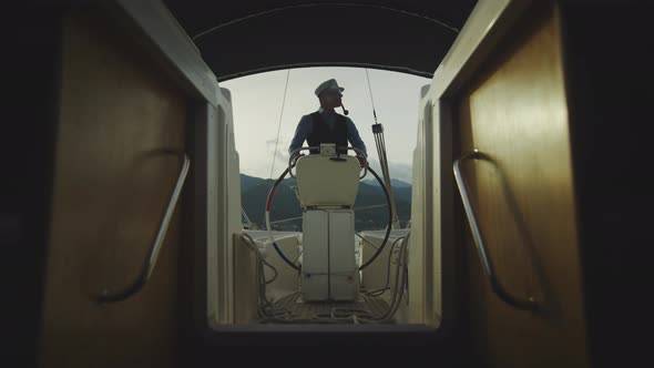 Sailor standing in cockpit and smoking