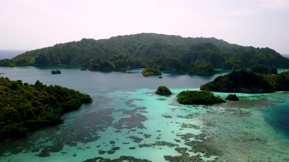 Reef between islands in Piaynemo on Raja Ampat Indonesia, Aerial lowering approach shot