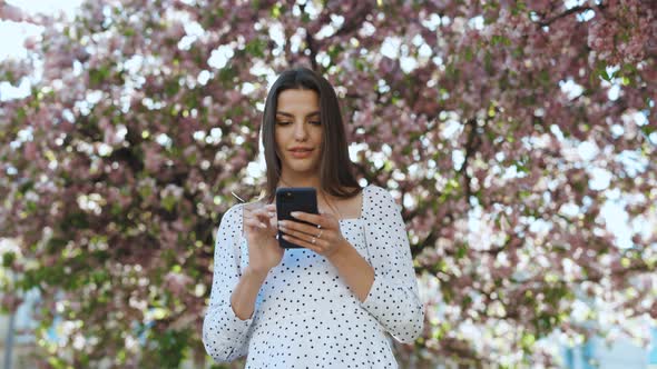 Woman Using Smartphone in the Park