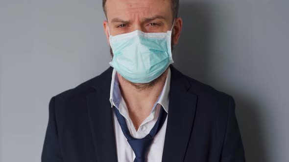 Pandemic Protection of the Covid-19 Coronavirus. Portrait of a Tired Caucasian Man in a Medical Face