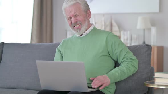 Old Man with Laptop Having Back Pain at Home