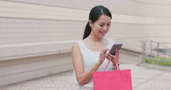 Shopping woman use of mobile phone at outdoor