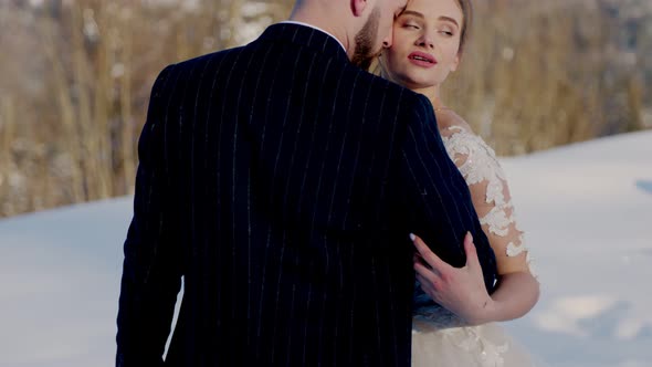 the Bride and Groom on the Background of the Mountains