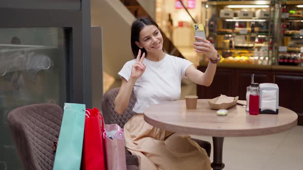 Attractive Woman Taking Selfie in Cafe After Shopping in Mall