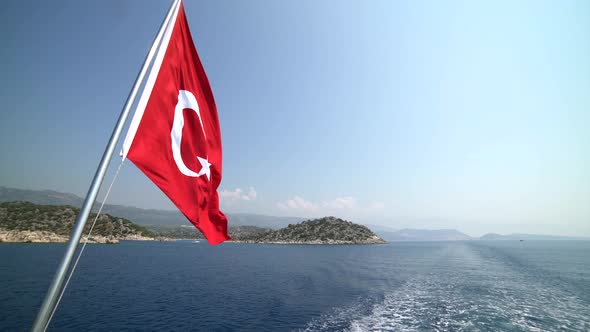 Turkish Flag Waving Behind the Boat, Symbolizing the Sea Holiday and Tourism in Turkey