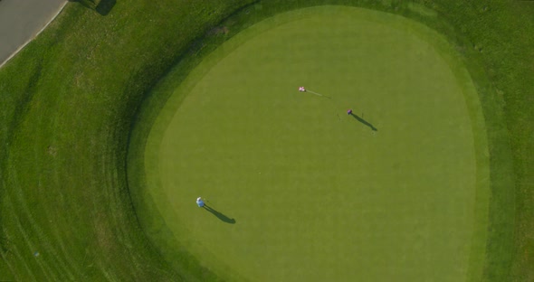 Top Down Aerial of People Playing Golf on a Sunny Day