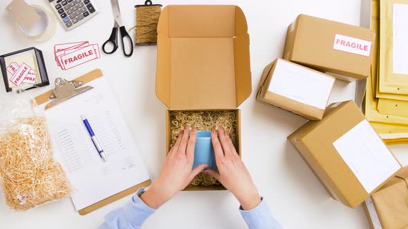 Woman Packing Mug To Parcel Box at Post Office 8