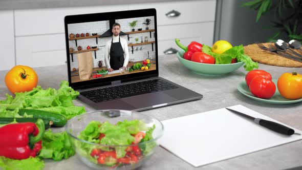 Close Up Laptop with Man Chef Food Blogger in Screen Tells Teaches Students