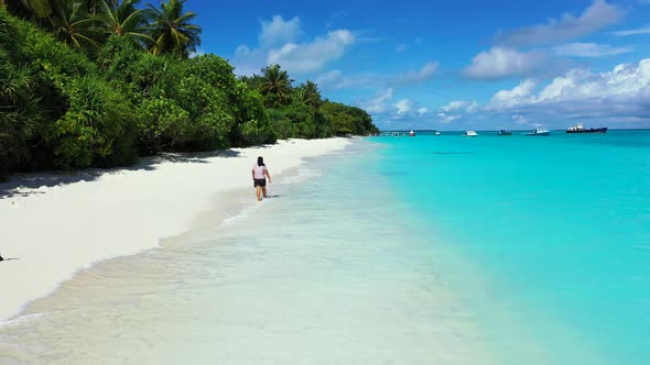 Sexy beauty model on holiday by the sea on beach on clean white sand and blue background 4K