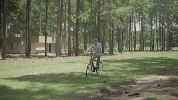 Mature man riding bicycle in park