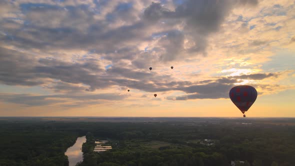 Aerial Drone View of Colorful Hot Air Balloons Flying Over Green Park and River in Small European