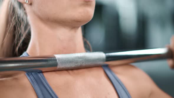 Extreme Closeup Girl Raising Up Heavy Barbell Practicing Bodybuilding