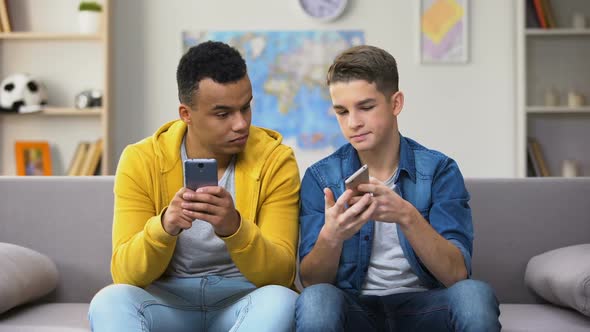 African-American and Caucasian Teens Playing Games on Phones, Showing Results