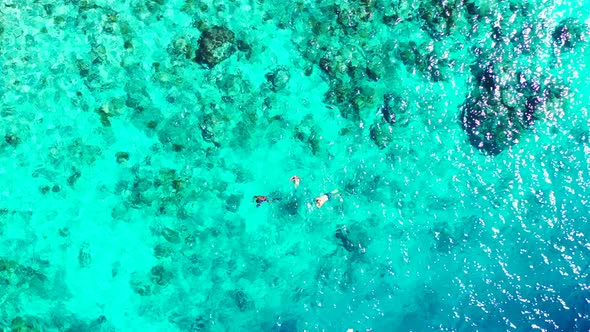 Aerial drone view panorama of beautiful resort beach vacation by blue green water and white sandy ba