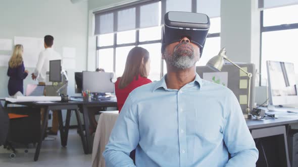 Businessman using VR headset in modern office