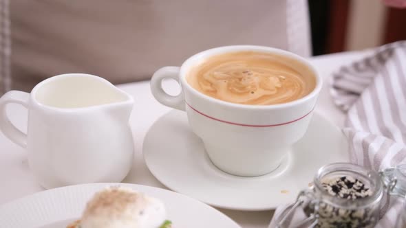 Closeup Shot of Woman Puts Brown Sugar Into Cup of Coffee