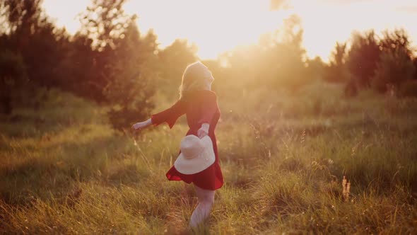 Portrait of Positive Smiling Woman Looking Into Camera at Sunset