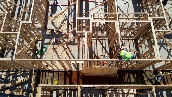 Aerial View of a New Building Being Framed By Carpenters