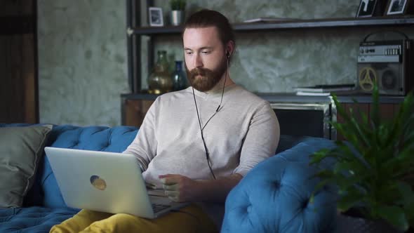 Man Nodding When Listening to Online Internet Tutor on Laptop Video Call Spbd