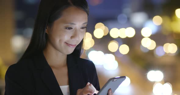 Businesswoman use cellphone at night