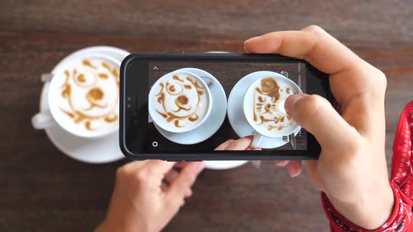 Woman Hands Taking Pictures Of Coffee With Smartphone In Cafe