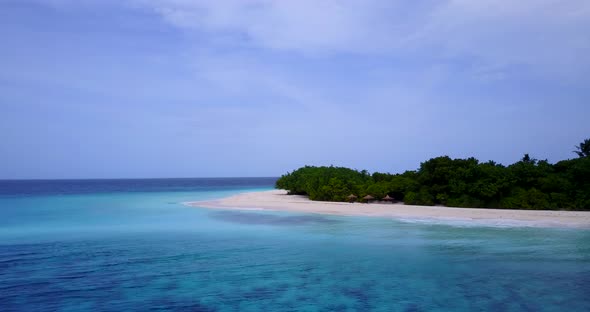 Daytime flying island view of a sunshine white sandy paradise beach and aqua blue ocean background 