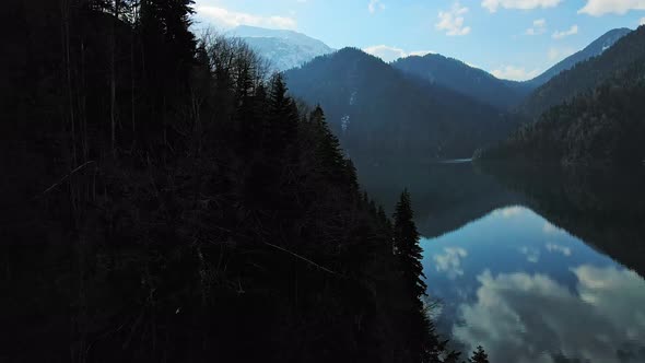 Clear Blue Mountain Lake with Reflection of Clouds on the Water