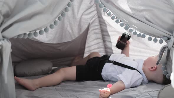 Little Boy Resting in a Children's Tent