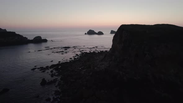 Beautiful high cliffs in the calm Bay of Biscay just after a sunset in Suances in the province of Ca