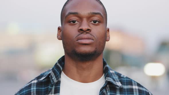 Portrait Outdoors Serious Angry Male Face African American Man Looking at Camera Standing in Urban