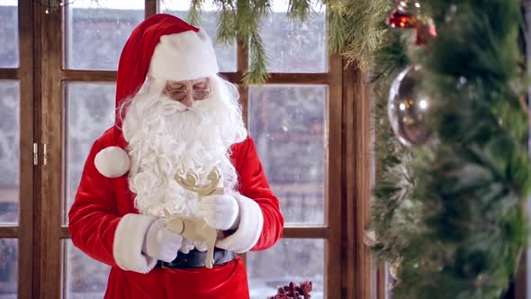 Santa Claus interiors. Santa Claus in living room decorated for christmas