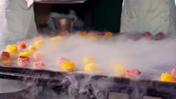 Beautiful view of making modern ice-cream with fruit in thick white steam.