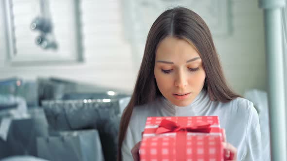 Young Women is Unhappy About Her Christmas Gift and Looking Sad